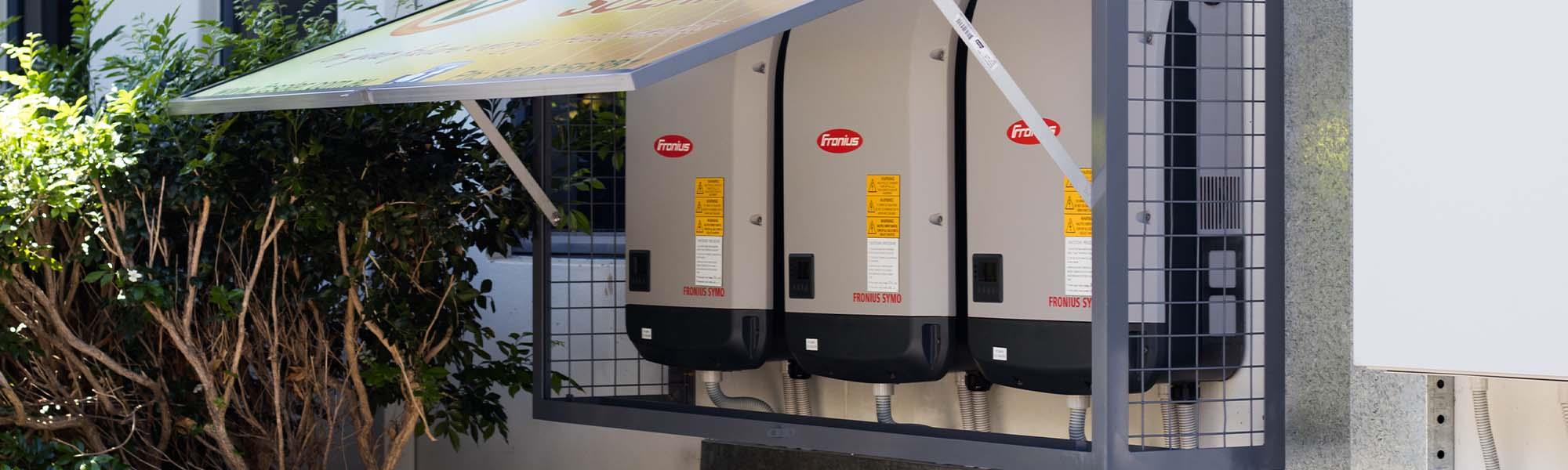 solar inverters on side of building
